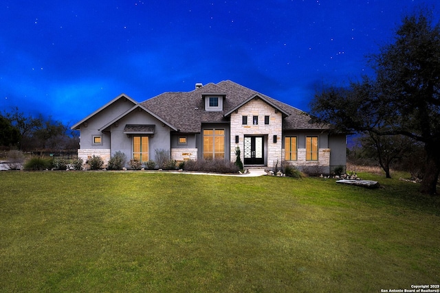 view of front of property featuring stone siding and a front lawn