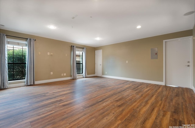 unfurnished room with baseboards, dark wood finished floors, a wealth of natural light, and recessed lighting