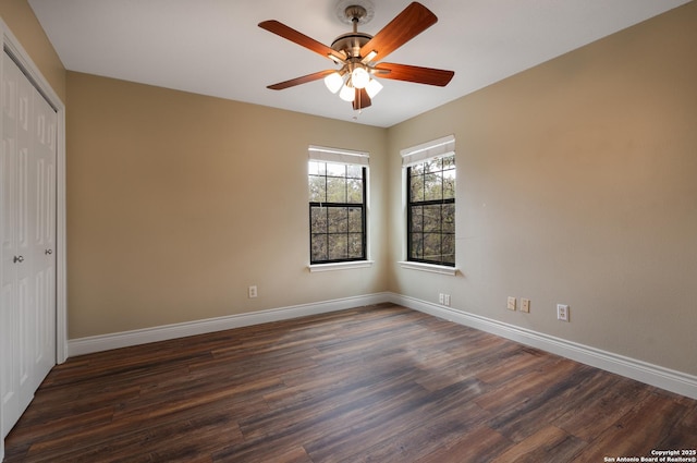 interior space featuring dark wood-type flooring, a closet, ceiling fan, and baseboards