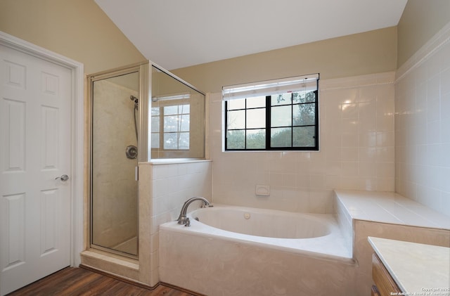 full bathroom with a garden tub, wood finished floors, a shower stall, and vanity