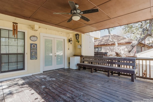 deck featuring a ceiling fan, french doors, and a mountain view