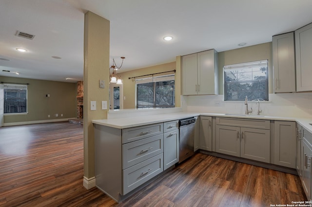 kitchen featuring light countertops, visible vents, gray cabinetry, stainless steel dishwasher, and a sink