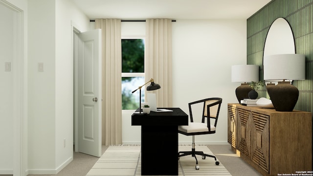 home office with baseboards and light colored carpet