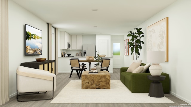 living room with light wood-style flooring and baseboards