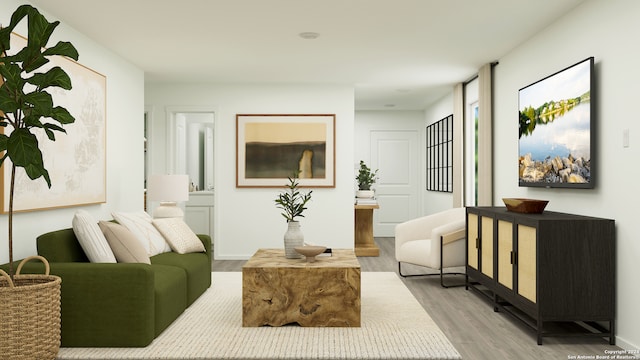 living area featuring light wood finished floors and baseboards