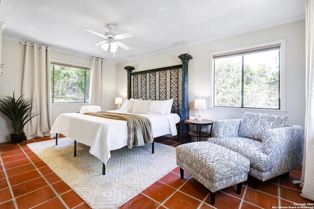 tiled bedroom with a ceiling fan and crown molding