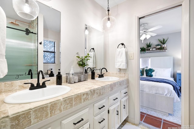 bathroom featuring a sink, double vanity, ensuite bath, and tile patterned floors