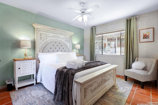 bedroom featuring dark tile patterned floors, baseboards, and ceiling fan