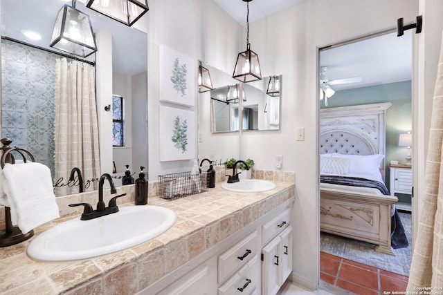 ensuite bathroom featuring a sink, ceiling fan, connected bathroom, and tile patterned floors