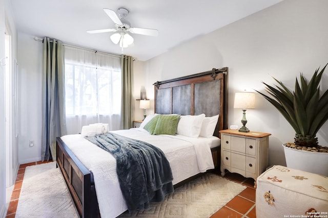 bedroom featuring light tile patterned floors and ceiling fan