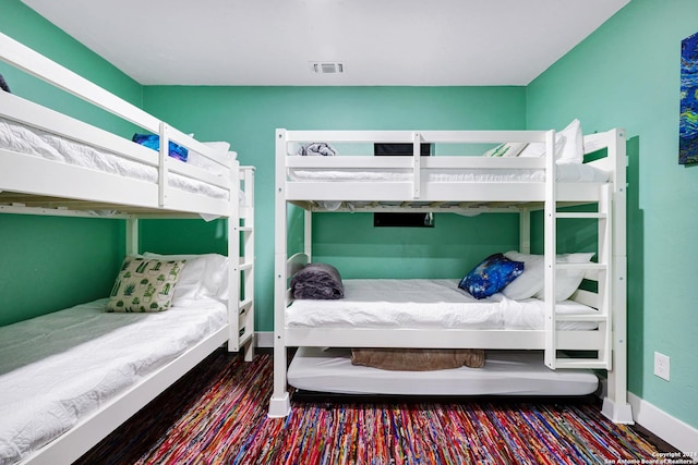 bedroom featuring visible vents and baseboards