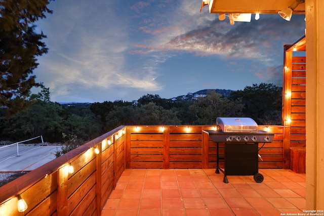 view of patio featuring a grill and a view of trees