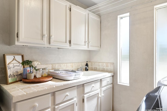 clothes washing area with a sink