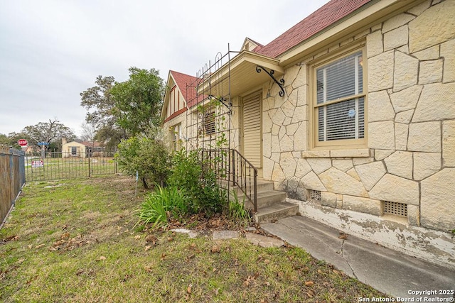 view of home's exterior featuring crawl space, fence, and a yard