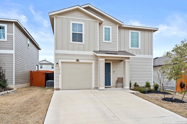 traditional-style home with driveway, central AC unit, an attached garage, fence, and board and batten siding