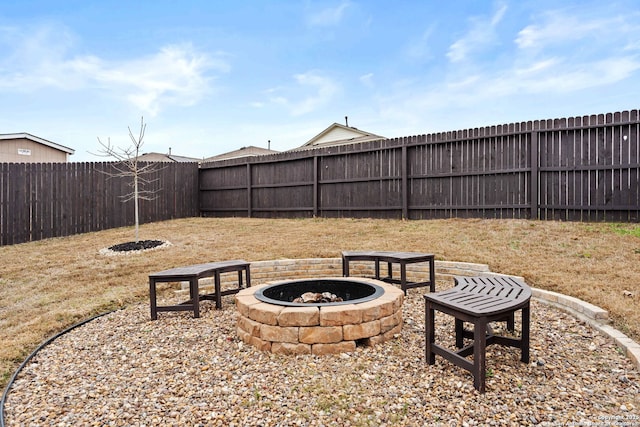 view of yard featuring an outdoor fire pit and a fenced backyard