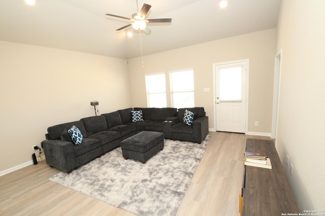 living area with ceiling fan, baseboards, and wood finished floors