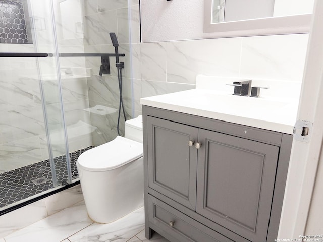 full bath with toilet, marble finish floor, vanity, a shower stall, and tile walls