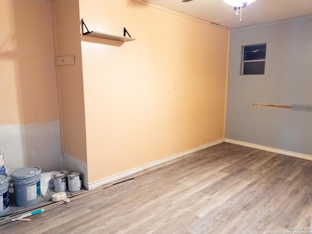 unfurnished room with ceiling fan, baseboards, and wood finished floors