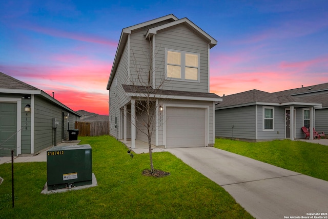 view of front of property with a garage, fence, concrete driveway, and a yard