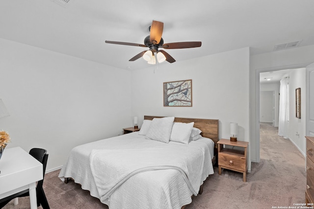 carpeted bedroom featuring baseboards, visible vents, and a ceiling fan