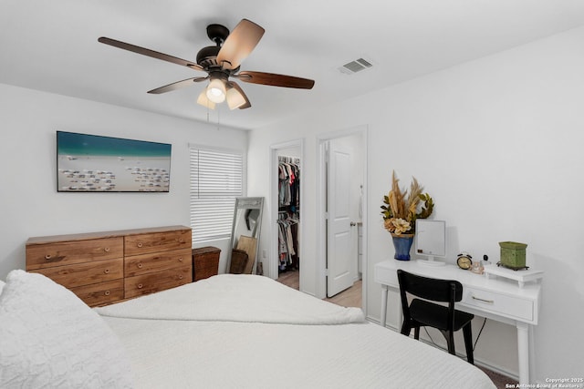 bedroom with a ceiling fan, a closet, visible vents, and a spacious closet