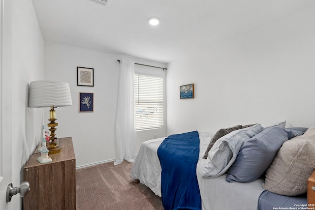 bedroom featuring baseboards and dark colored carpet