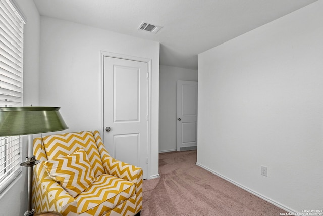 unfurnished room with light carpet, visible vents, and baseboards