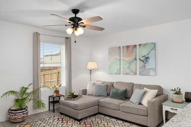 living room with a ceiling fan and light wood finished floors