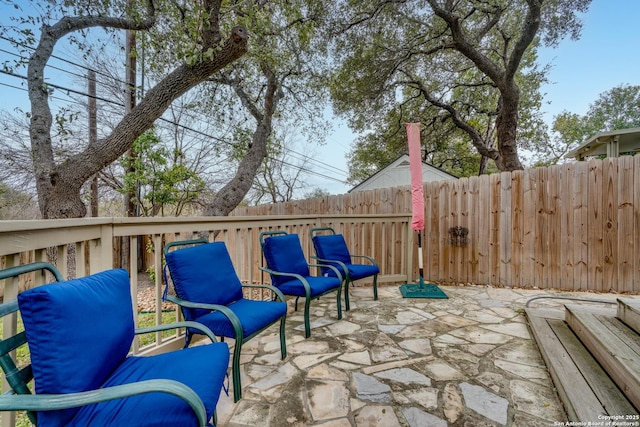 view of patio / terrace featuring fence