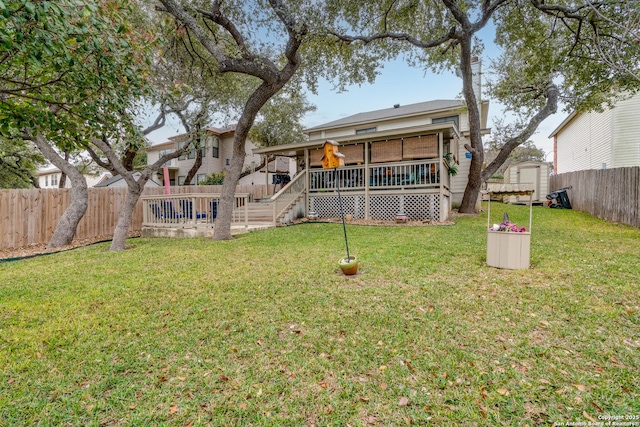 rear view of property with a fenced backyard, a shed, a deck, and a yard