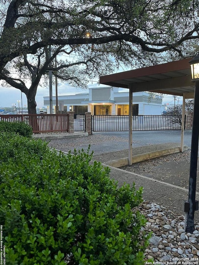 exterior space featuring a carport and fence