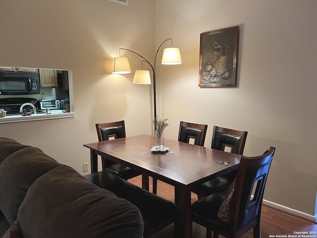 dining area featuring baseboards and wood finished floors