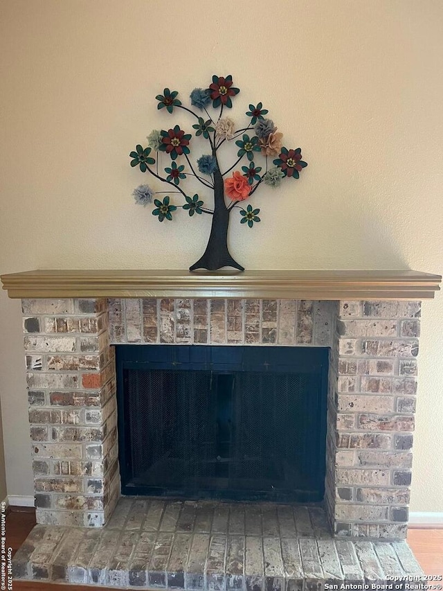 room details featuring a fireplace and baseboards