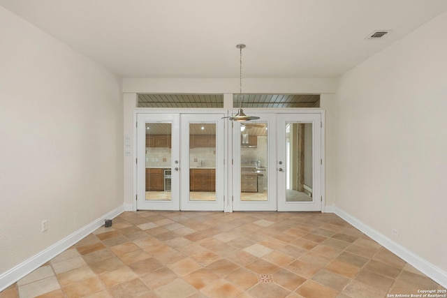 unfurnished dining area with french doors, visible vents, and baseboards