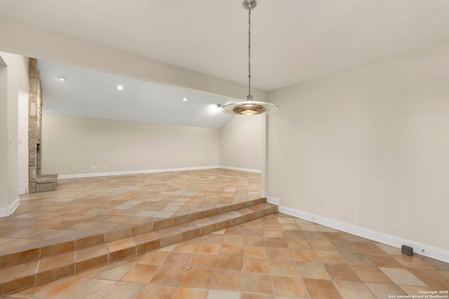 unfurnished room featuring lofted ceiling, baseboards, and recessed lighting