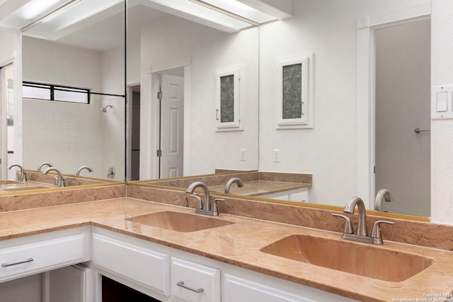 full bathroom with double vanity and a sink