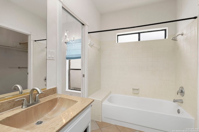 full bath featuring shower / washtub combination, a walk in closet, vanity, and tile patterned floors