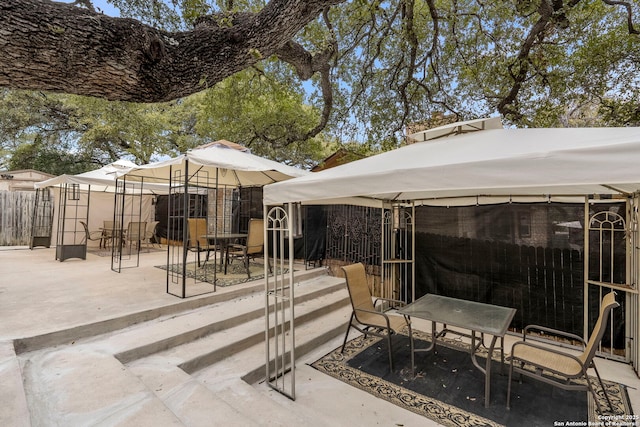 view of patio / terrace featuring a gazebo and fence