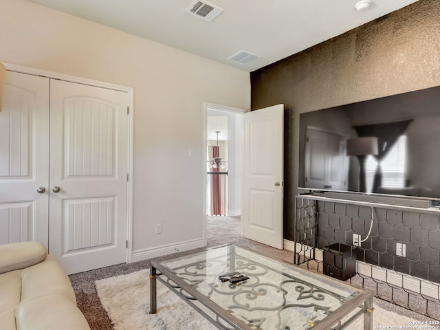 living area with carpet, visible vents, and baseboards