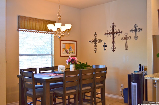 dining space featuring light tile patterned floors and a chandelier