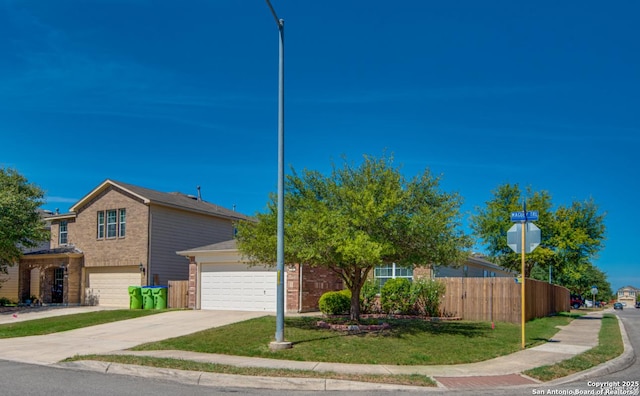 view of front of home with driveway, fence, and brick siding