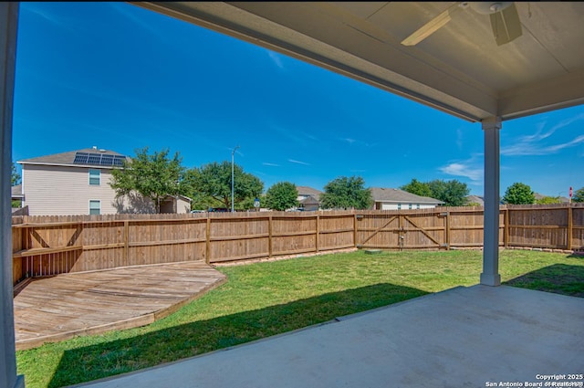 view of yard with a fenced backyard, a patio, and ceiling fan