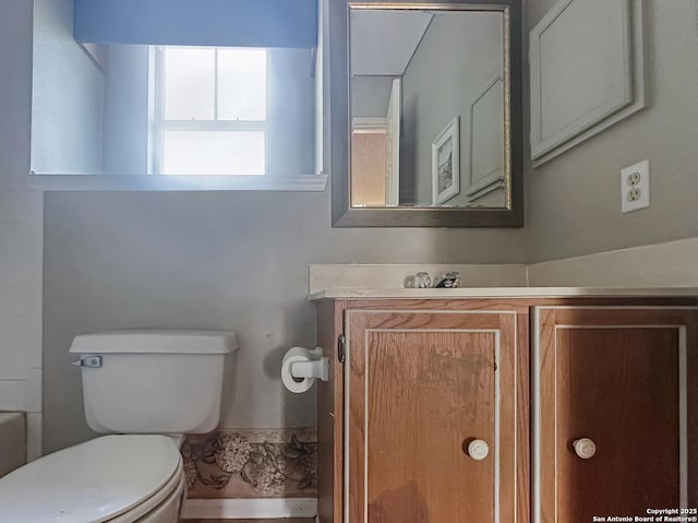 bathroom featuring toilet and vanity