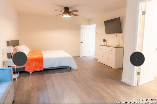 bedroom with light wood-style floors and baseboards