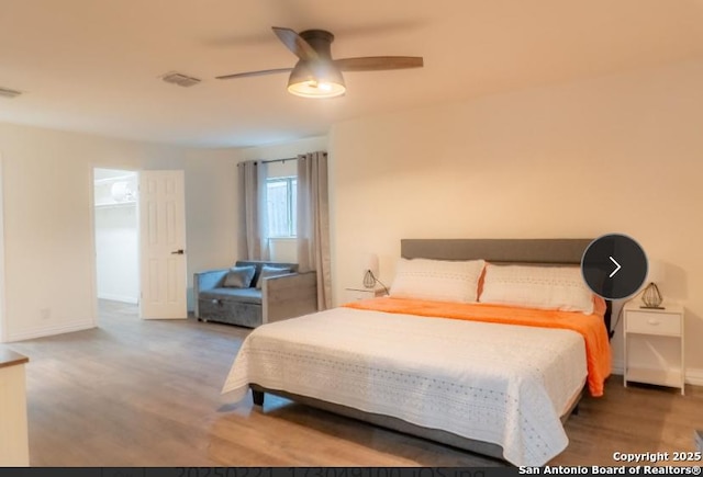 bedroom featuring ceiling fan, wood finished floors, visible vents, and baseboards