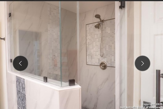 full bathroom featuring a marble finish shower