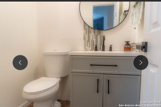 bathroom featuring toilet and vanity