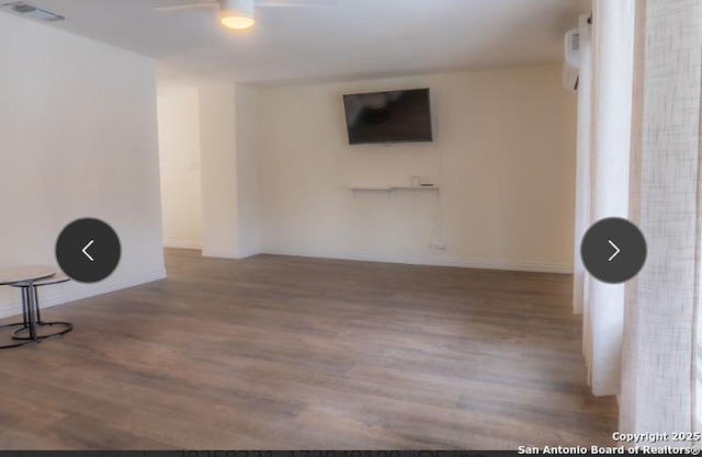 exercise room featuring visible vents, ceiling fan, baseboards, and wood finished floors