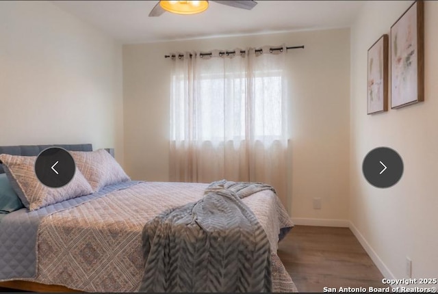 bedroom with a ceiling fan, baseboards, and wood finished floors